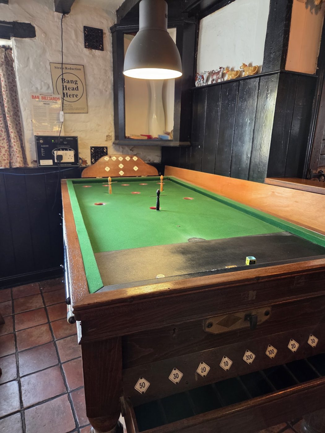 The pool table on a tiled floor