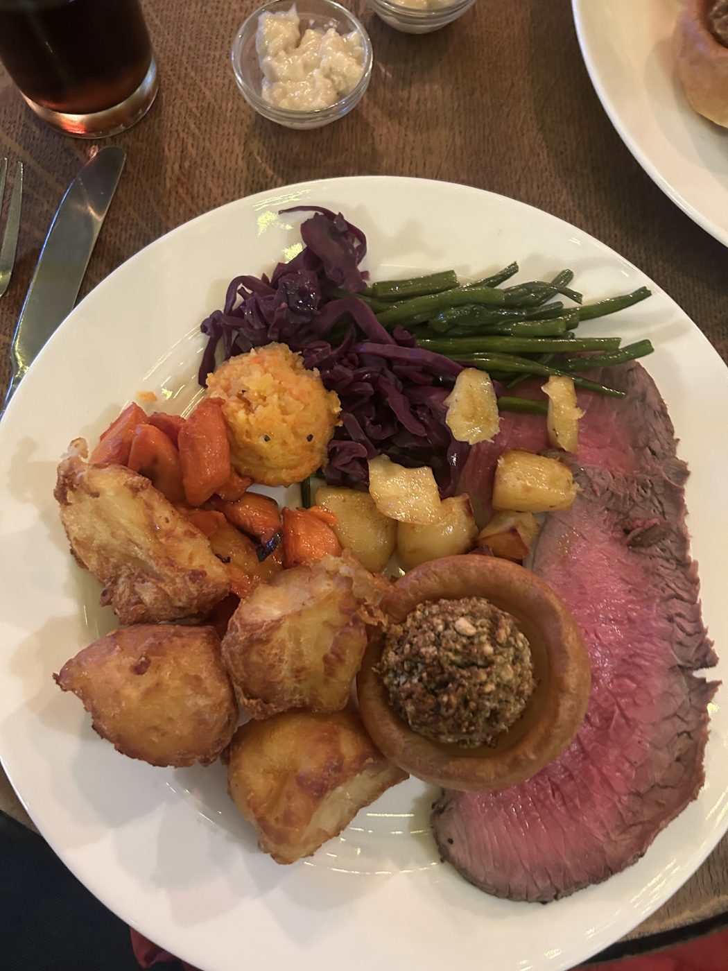 A roast beef dinner with potatoes and vegetables