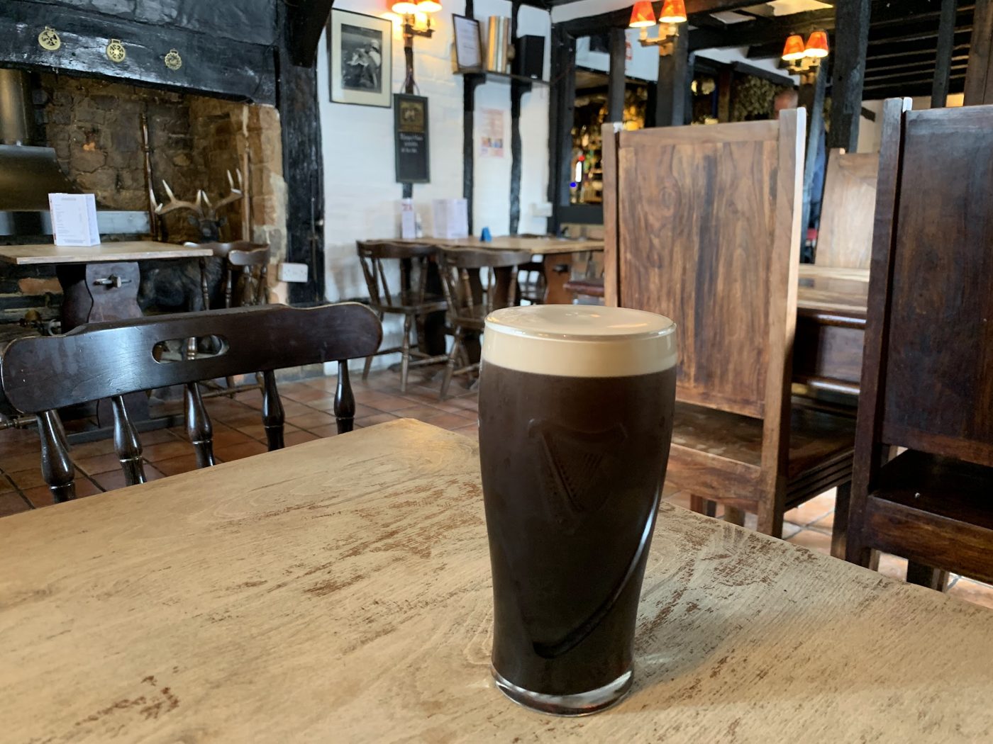 A pint of stout on a table in the bar
